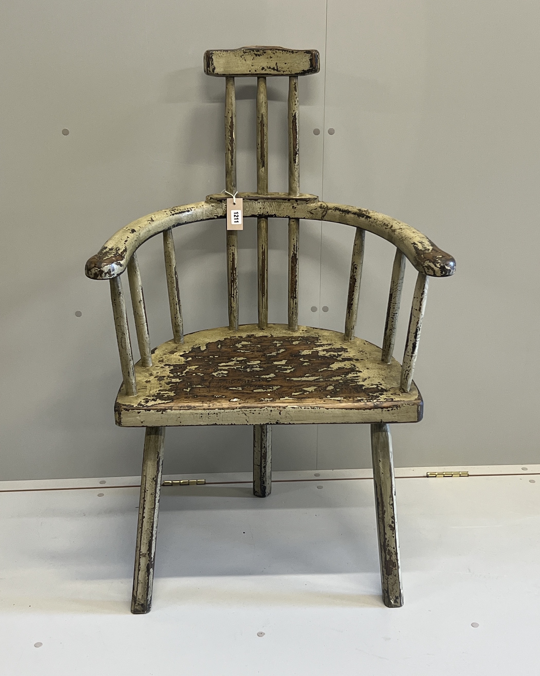 An 18th century style painted hardwood primitive elbow chair, width 68cm, depth 44cm, height 108cm